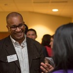 A guest of the event smiles at the woman he is talking to